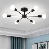Modern ceiling light fixture with six spherical bulbs in a room with light blue walls and framed pictures.